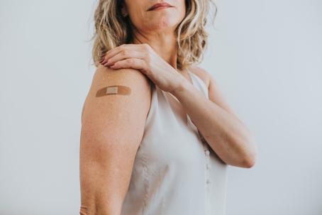 woman wearing a band-aid on her arm