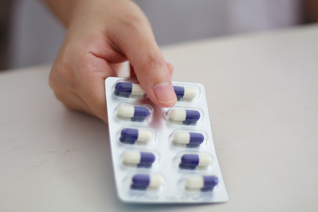 Close up of female doctor hands holding pills stock photo